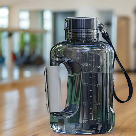 hydrogen water bottle with a black lid and handle on a wooden surface.