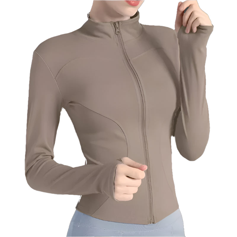 Woman wearing a cocoa zip up thumb hole jacket and light blue leggings showing the front view against a white background 
