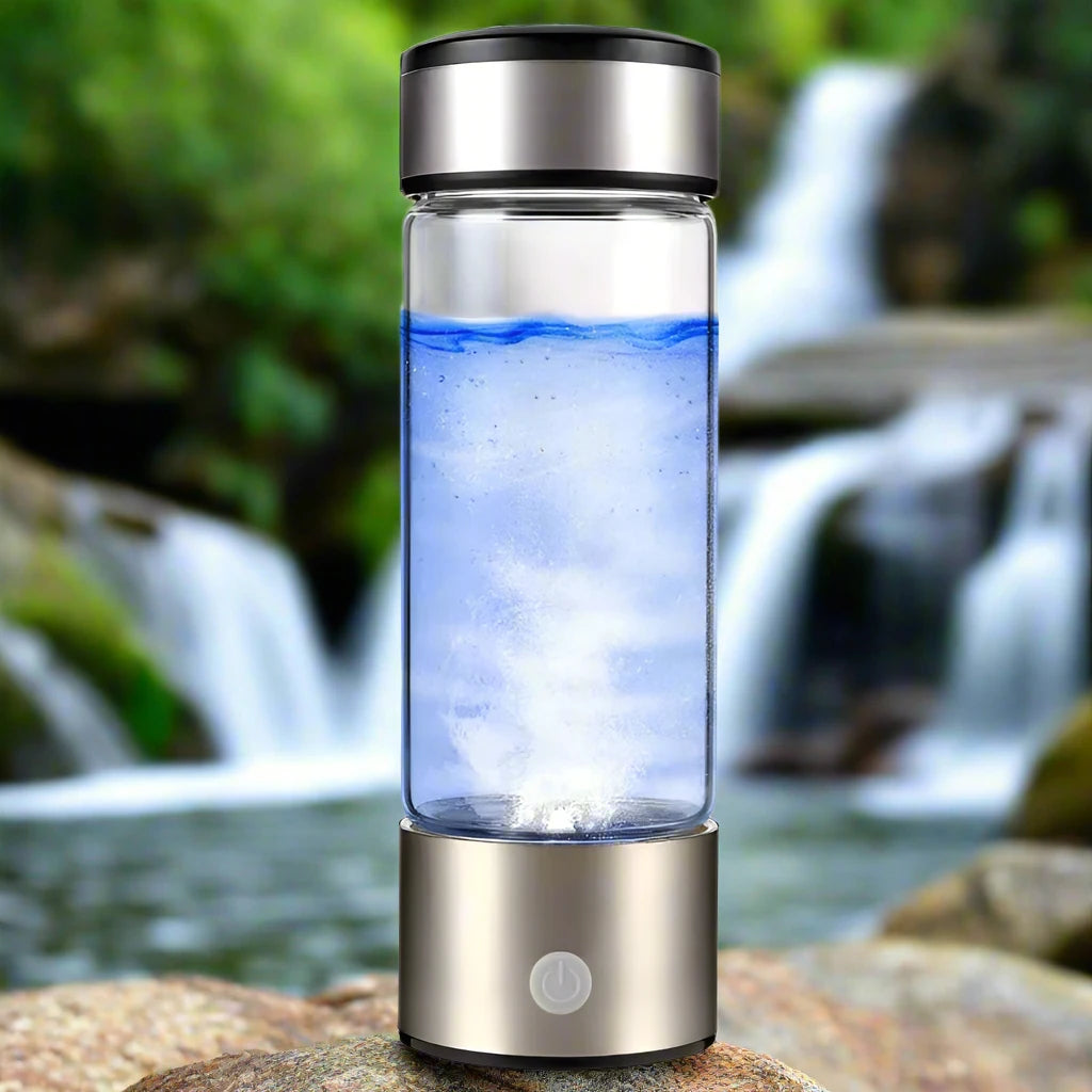 grey hydrogen glass water bottle with water on a natural background