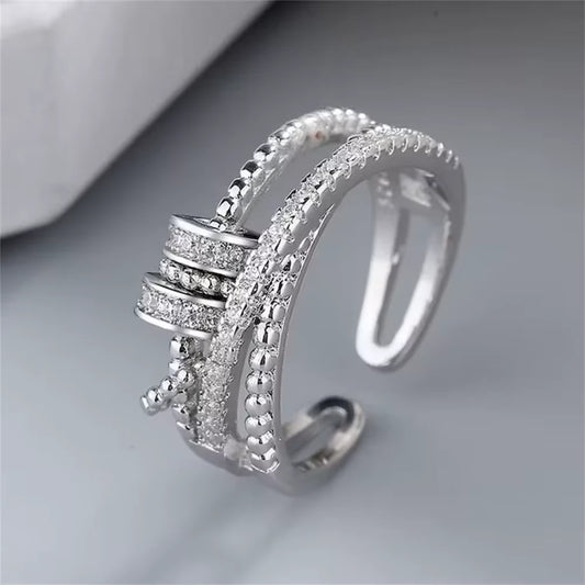 sterling Silver ring with intricate spinner design on a gray background